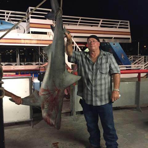 a man holding a fish